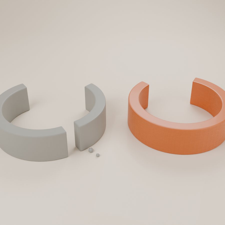 A grey broken plastic clip next to a new copper-orange printed replacement clip