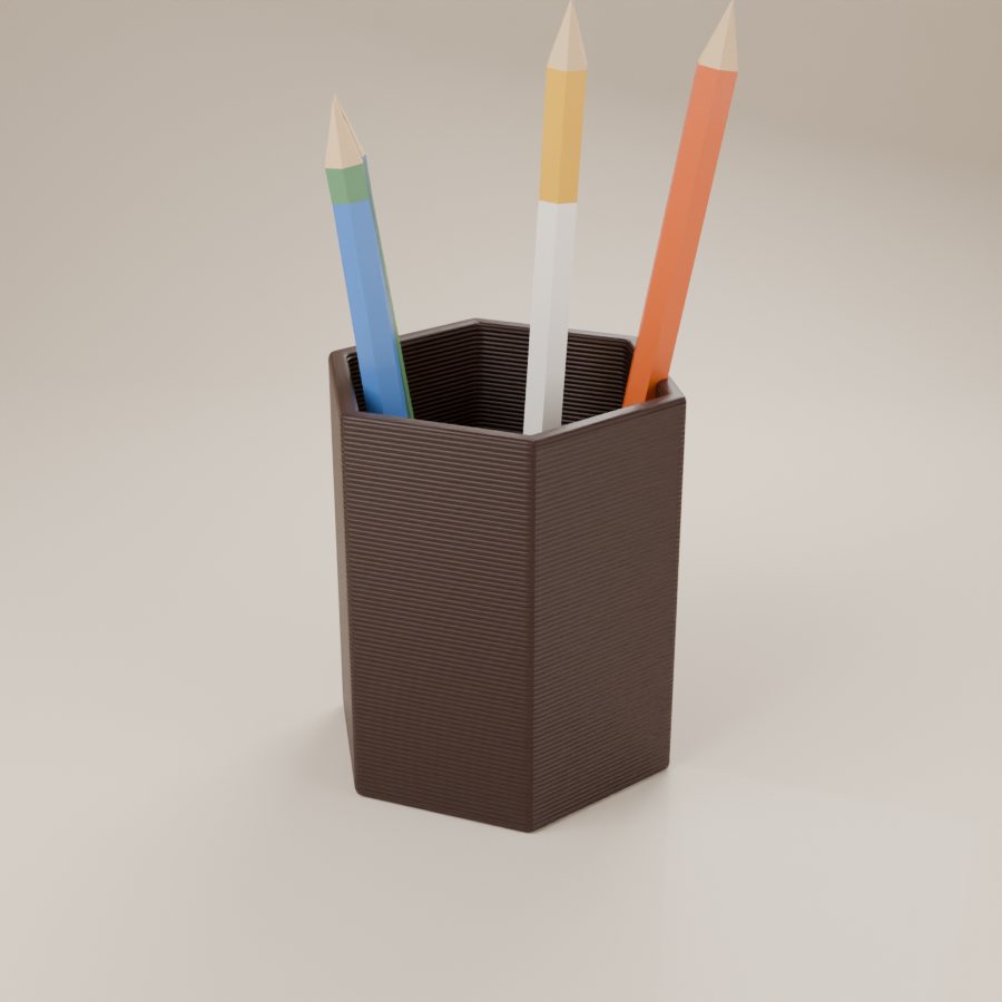A dark hexagonal 3D printed pen pot holding pencils